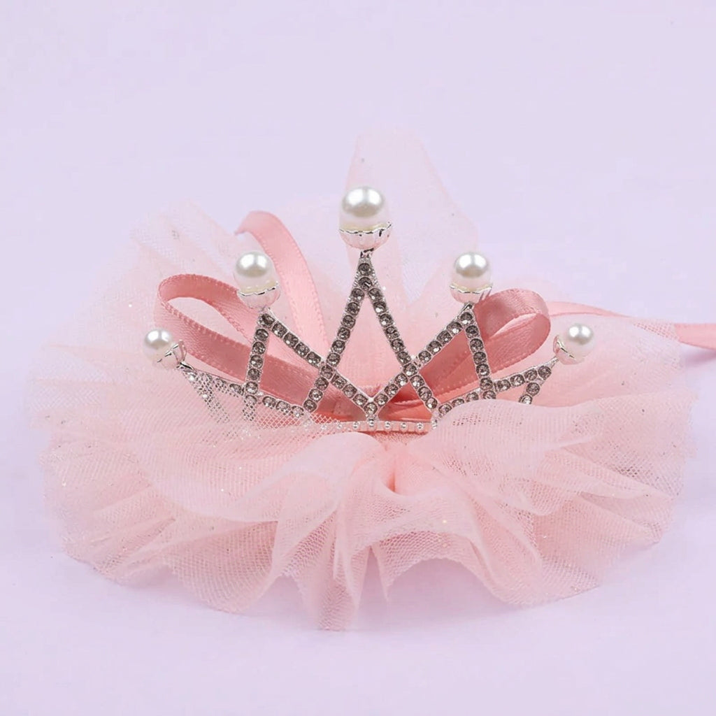 Silver rhinestone pet tiara with pearl-tipped points, pink tulle ruffles, and satin ribbon ties on a lavender background