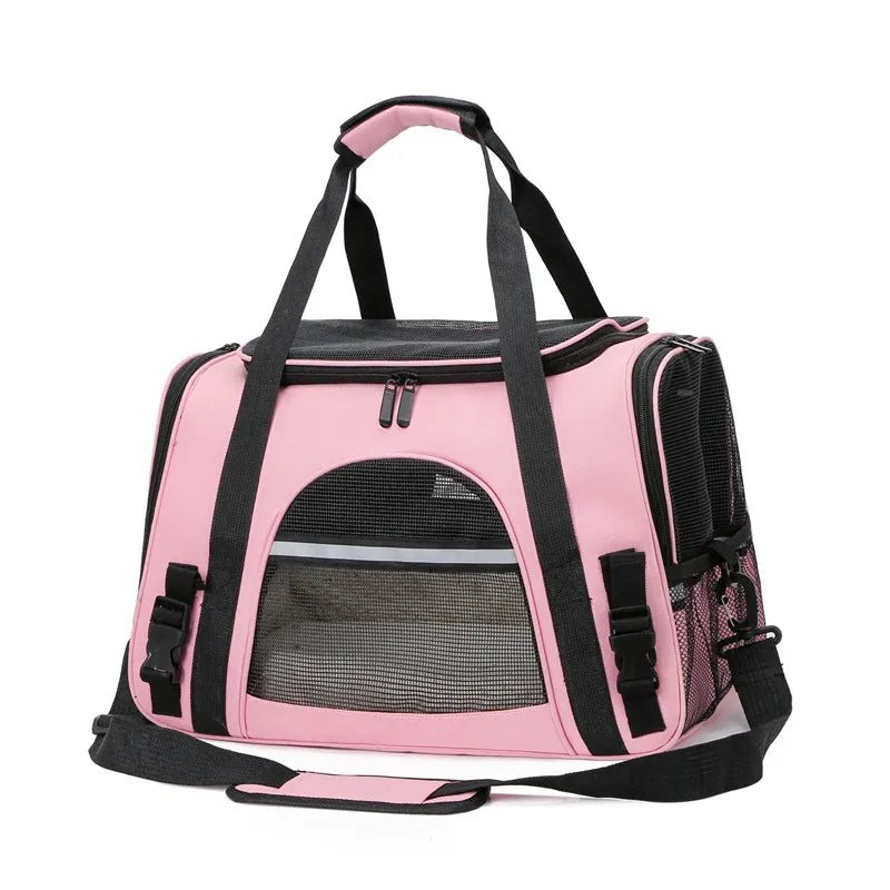 Pink pet carrier with black straps on a white background