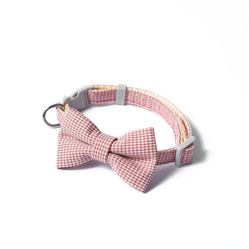 Dog collar with a red and white checkered bow tie on a white background