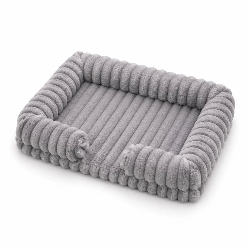 Light grey ribbed corduroy rectangular pet bed with raised bolster sides, shown at a 3/4 angle on a white background
