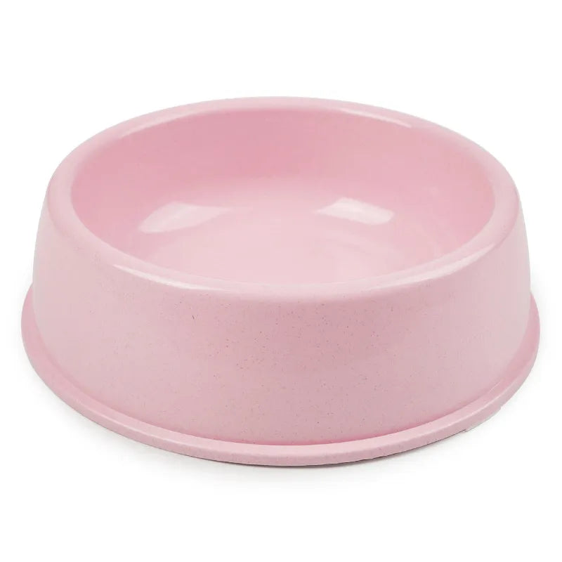 Simple pastel pink single pet bowl, plain matte plastic or ceramic, product photo on white background