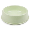 Simple pastel light green single pet bowl, plain matte plastic or ceramic, product photo on white background