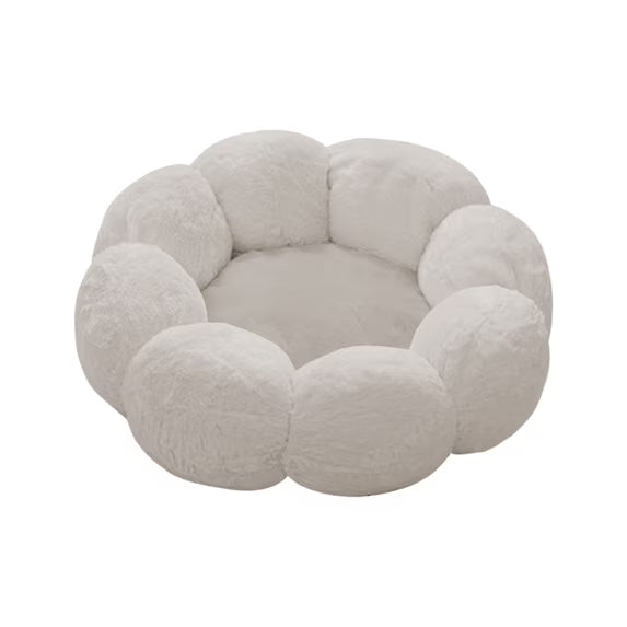 A plush, cloud-like pet bed with a scalloped, flower-petal border and a soft, circular cushion inside, shown on a solid white background.