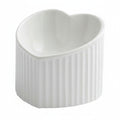 White ceramic heart-shaped pet bowl with ribbed exterior, white background
