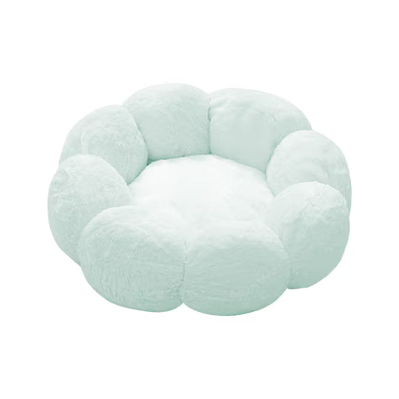 A fluffy, cloud-shaped pet bed in a pale mint green color, isolated on a solid white background.