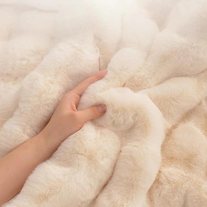 Close-up of a hand pressing into ultra-soft cream waffle-textured plush pet mat fabric showing deep cushioning and softness