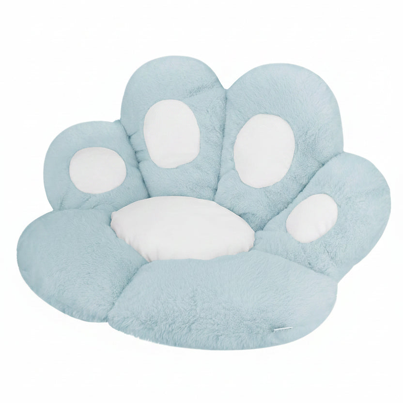 Powder blue and white plush paw-shaped pet bed cushion with white toe pad accents, shown at a 3/4 angle on a white background