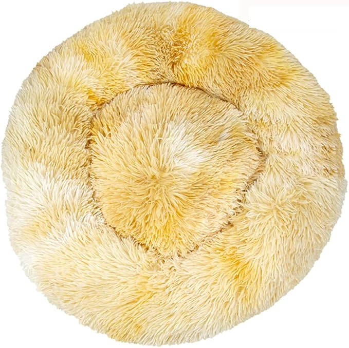 Round cream and golden yellow tie-dye shaggy faux fur donut calming pet bed top-down view on white background