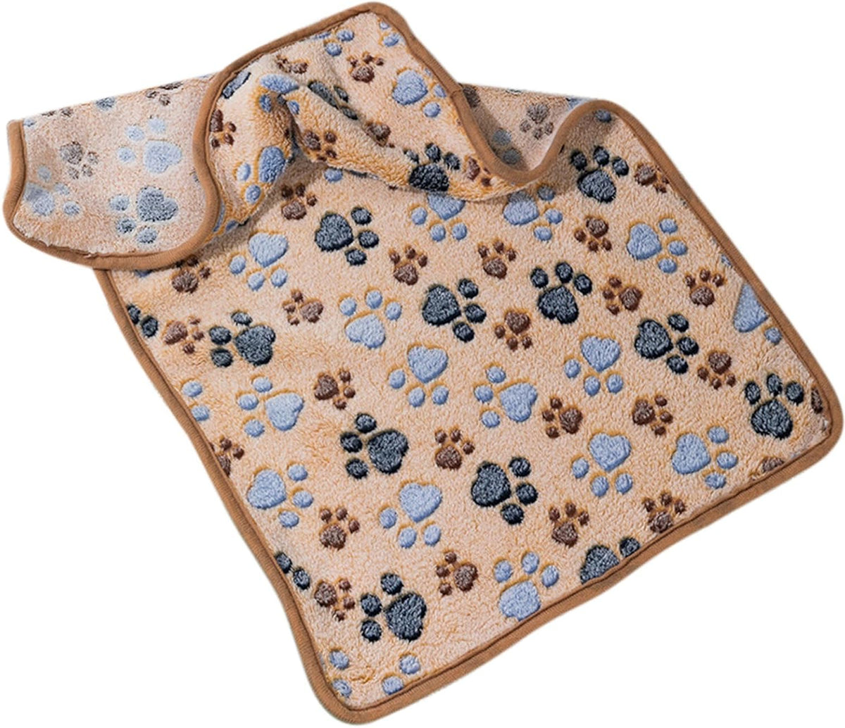 A fleece pet blanket with a matching soft pad, featuring a beige background patterned with blue, gray, and brown paw prints, shown on a plain white background.