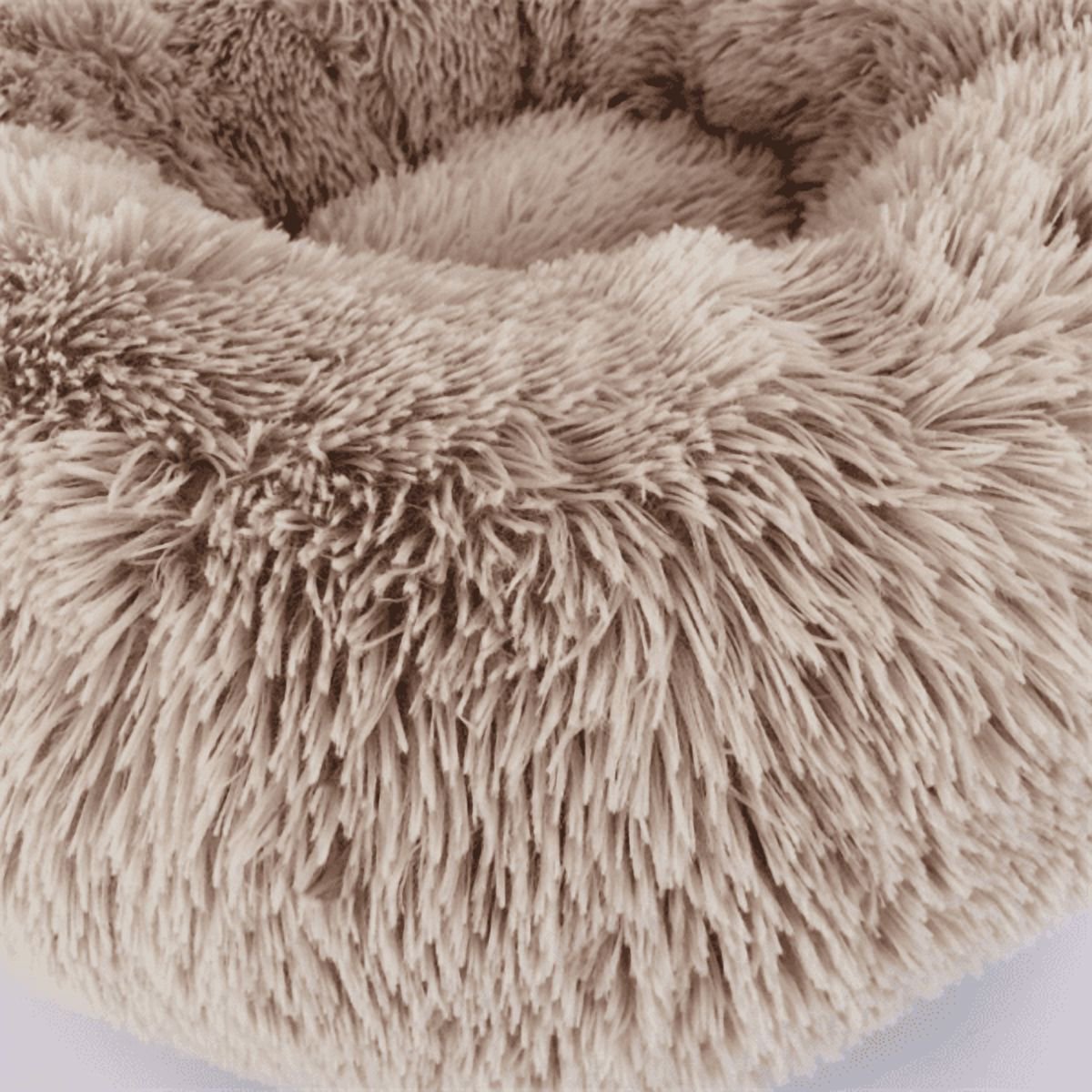 Close-up of a fluffy beige pet bed