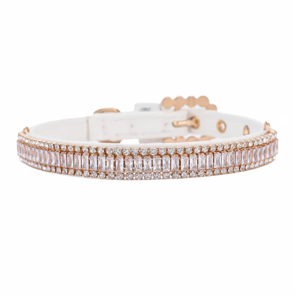 Pretty Posh Pets luxury rhinestone pet collar — front-facing view of a white leather collar featuring a row of emerald-cut clear crystal baguette gemstones bordered by two rows of sparkling round rhinestones in rose gold settings, with an adjustable buckle and eyelets on a white background.