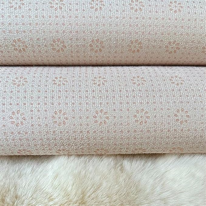 Close-up fabric detail of round plush pet mat showing non-slip textured bottom layer and ultra-soft cream faux fur top layer