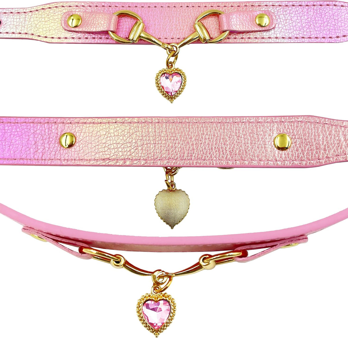 Three iridescent pink pet collars with gold snaffle-bit hardware and pink crystal heart charm pendants, shown in a close-up detail flat lay on a white background