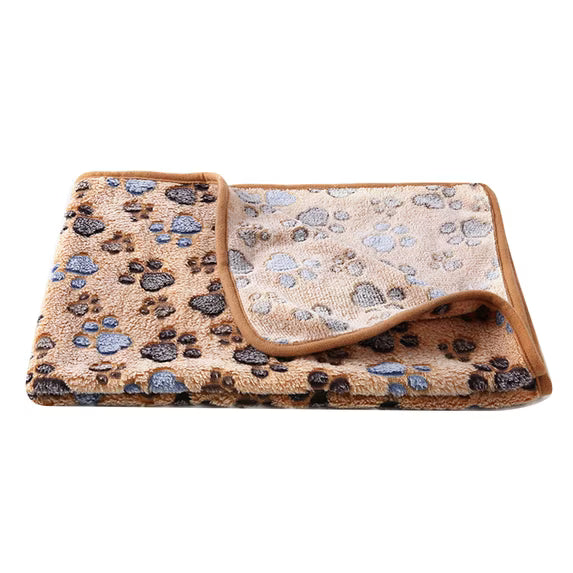 A folded pet blanket with a plush texture, featuring a brown and gray paw print pattern on one side and a light beige paw print pattern on the reverse, finished with a solid brown border.