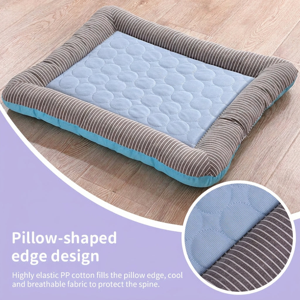 Pillow-shaped pet bed with blue cushion and brown edges on a wooden floor.