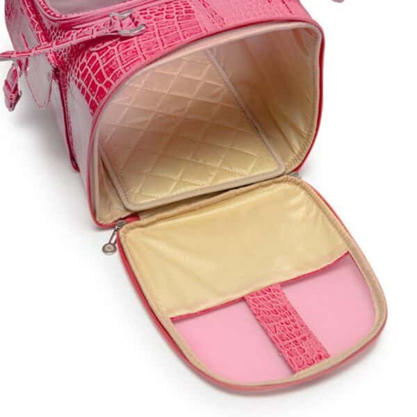 Pink pet carrier with quilted interior on a white background