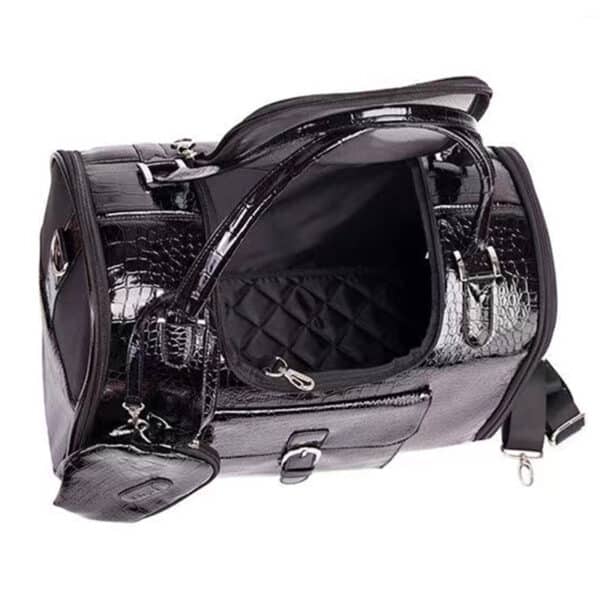 A black faux-croc patent leather pet carrier with an open top handle and a detachable shoulder strap, shown against a plain white background.