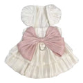 Ivory dog princess dress with puff sleeves, a ruffled skirt, oversized blush pink bow, and silver-tone leash D-ring