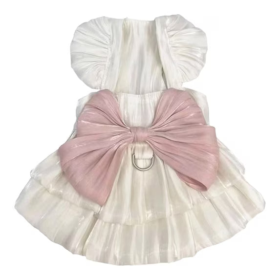 Ivory dog princess dress with puff sleeves, a ruffled skirt, oversized blush pink bow, and silver-tone leash D-ring