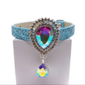 Light blue glitter dog collar with large aurora borealis teardrop crystal sunburst centerpiece and dangling AB crystal drop on white stand