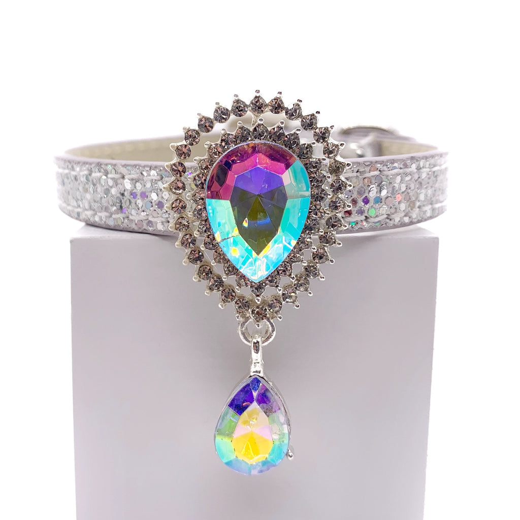 Silver glitter dog collar with large aurora borealis teardrop crystal sunburst centerpiece and dangling AB crystal drop on white stand