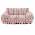 Blush pink rectangular pet sofa bed with thick ribbed channel-tufted plush fabric, rounded raised back and armrests, and a deep cushioned seat, shown from the front on a white background
