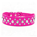 A bright pink dog collar embellished with multiple round silver rhinestones, shown against a plain white background.