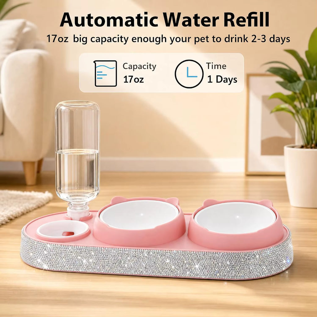 Pink pet water refill station with two bowls, a clear water bottle, and a rhinestone-embellished base on a wooden floor, with marketing text and icons above showing 17oz capacity and 1-day refill time.