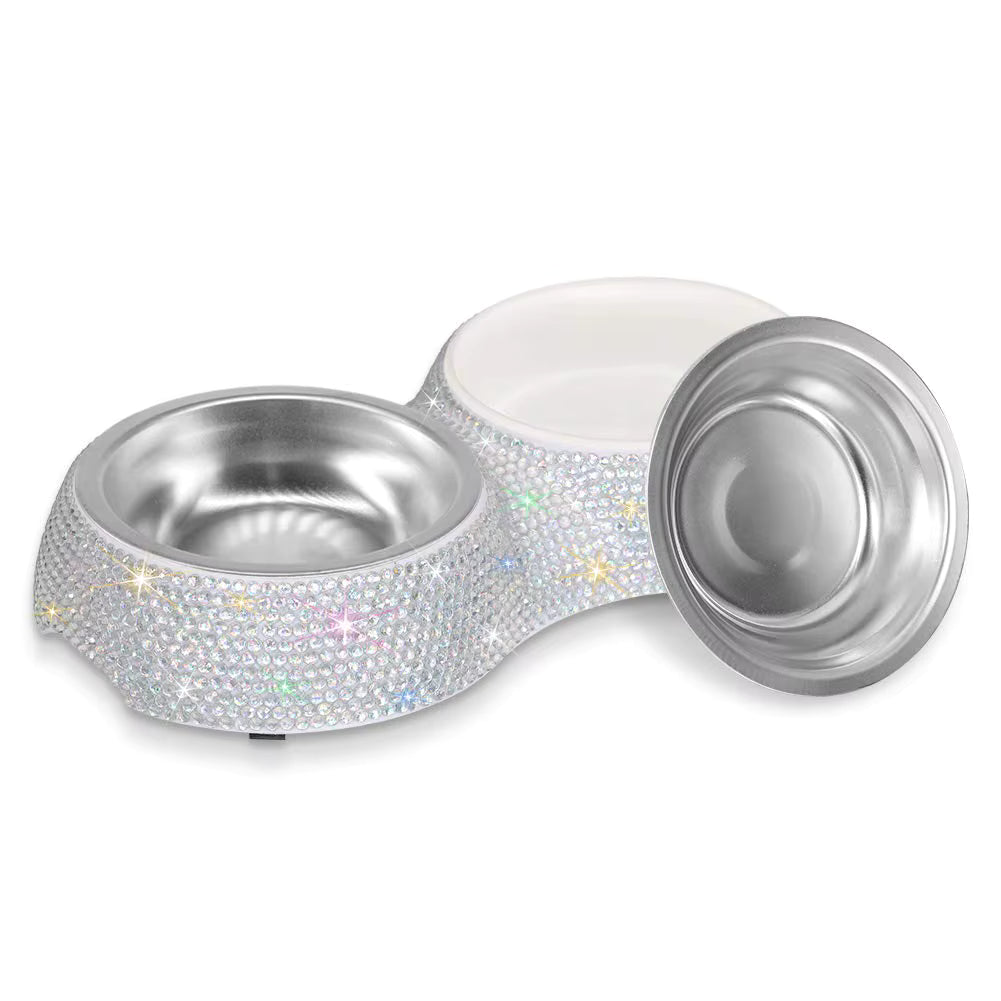 A double pet feeder and waterer bowl set with a white plastic outer body covered in iridescent rhinestones and star-shaped accents, featuring stainless steel interiors and a separate metal lid, shown on a white background.