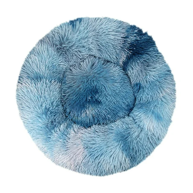 Round blue and white tie-dye shaggy faux fur donut calming pet bed top-down view on white background