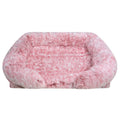 Blush pink long shaggy faux fur rectangular pet sofa bed with raised bolster sides and a flat cushioned center, shown from the front on a white background