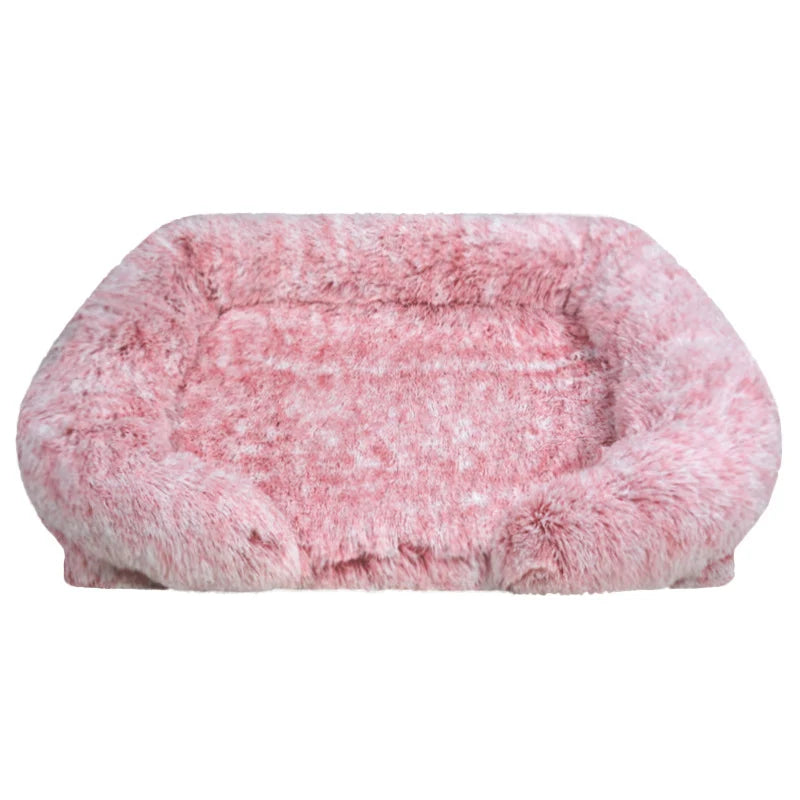 Blush pink long shaggy faux fur rectangular pet sofa bed with raised bolster sides and a flat cushioned center, shown from the front on a white background