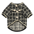 Black and white tweed pet jacket centered on a square white background