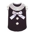 Black pet top with white ruffled collar, bow, and flowers, straightened on pure white