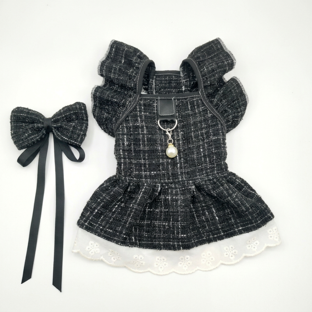 Black tweed ruffled pet dress with white lace hem and matching bow on white