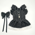 Black tweed ruffled pet dress with white lace hem and matching bow on white