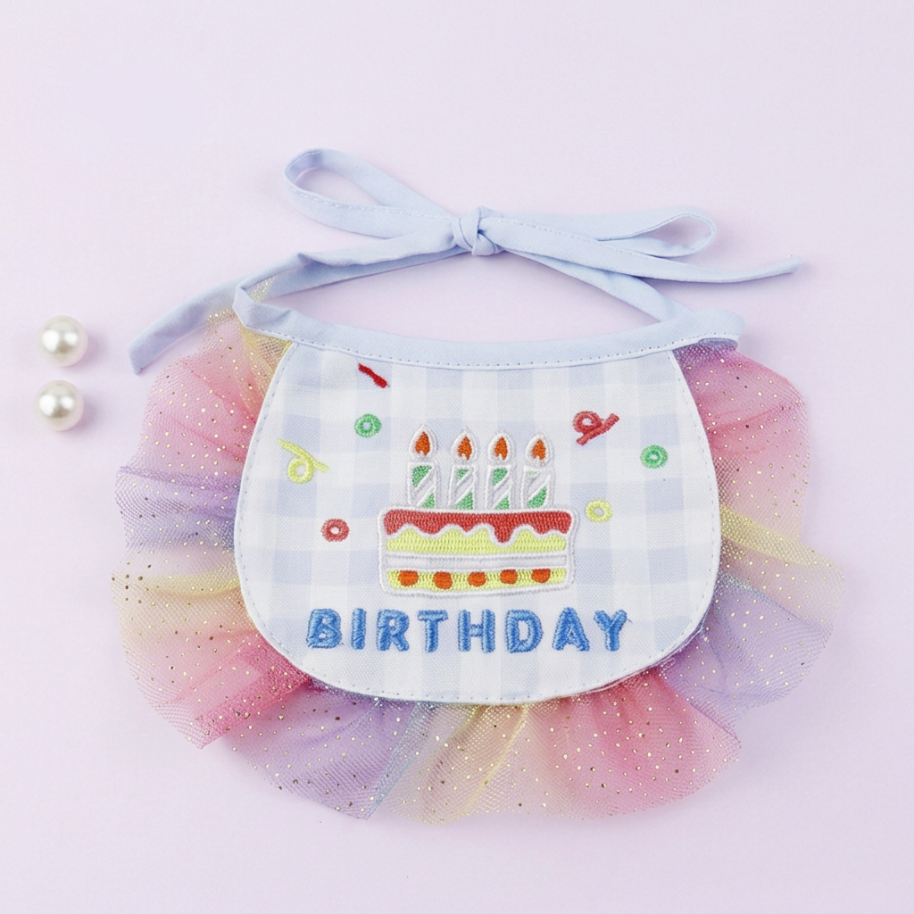 Blue birthday bib on a very light lavender background