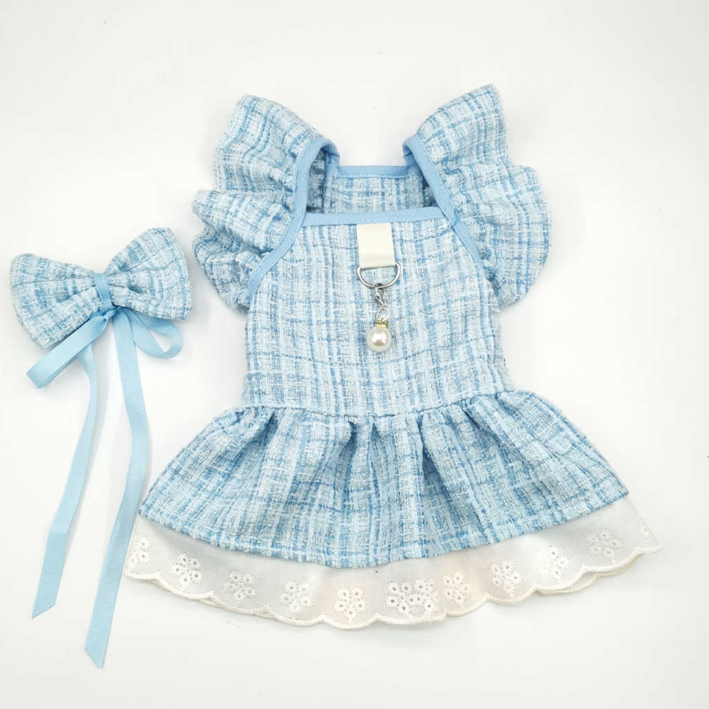Blue ruffled pet dress and matching ribbon bow on a square white background