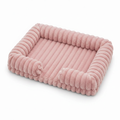 Blush pink ribbed corduroy rectangular pet sofa bed with raised bolster sides, shown at a 3/4 angle on a white background