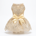 Champagne embroidered pet dress with satin bow on a clean white background