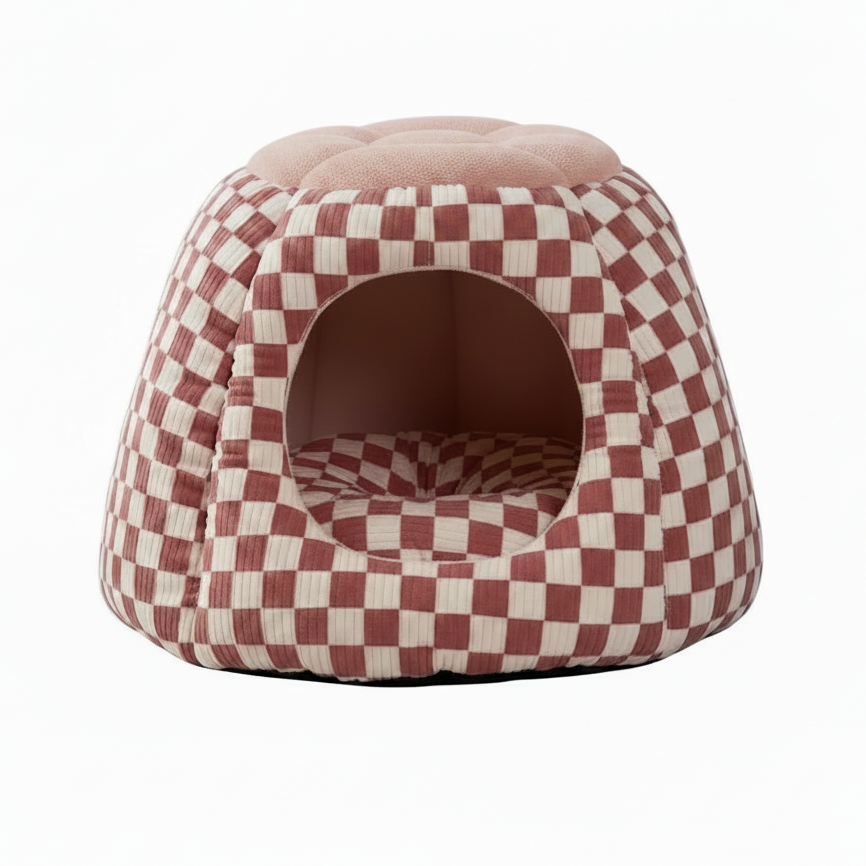 Dusty rose and cream checkerboard print igloo cave pet bed with a round tufted blush pink boucle top, circular arched entrance, and matching checkered interior cushion, on a white background