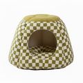 Olive green and cream checkerboard print igloo cave pet bed with a round tufted olive green boucle top, circular arched entrance, and matching checkered interior cushion, on a white background