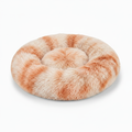 Round cream and caramel tie-dye shaggy faux fur donut calming pet bed three-quarter view on white background