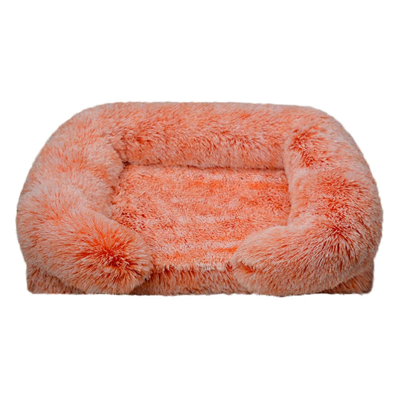 Peach coral long shaggy faux fur rectangular pet sofa bed with raised bolster sides and a flat cushioned center, shown at a slight angle on a white background