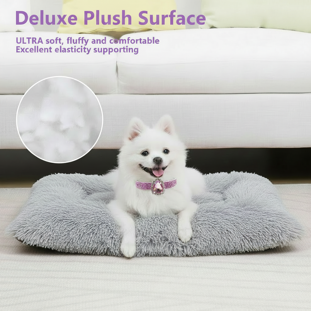 Feature infographic with lavender text reading Deluxe Plush Surface — Ultra soft, fluffy and comfortable, Excellent elasticity supporting, showing a white Japanese Spitz wearing a pink glitter collar with a large pink teardrop gemstone pendant lying on a light grey long shaggy faux fur rectangular pet bed mat in front of a white upholstered sofa, with a close-up inset of the plush fabric texture