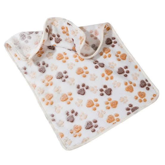 Flannel blanket with paw print pattern on a white background