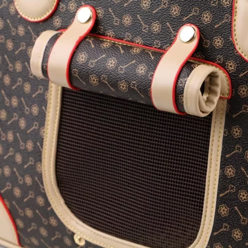 Close-up of a patterned pet carrier handle and body