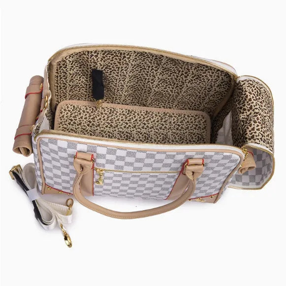 Designer pet carrier with leopard print interior on a white background