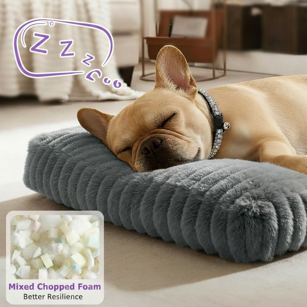 Fawn French Bulldog wearing a rhinestone collar sleeping on a grey ribbed plush rectangular pet mat in a warm neutral living room, with a mixed chopped foam fill callout graphic