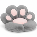 Grey and blush pink plush paw-shaped pet bed cushion with pink toe pad accents, shown at a slight angle on a white background